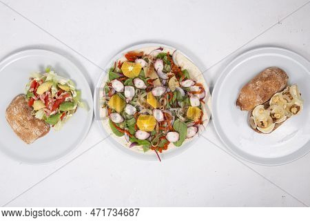 Vegetarian Salads And Sandwiches On Dining Table