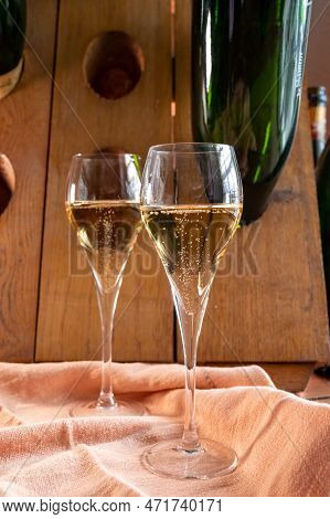 Glasses Of Sparkling White Wine Champagne Or Cava With Bubbles And Classic Wooden Champagne Pupitre