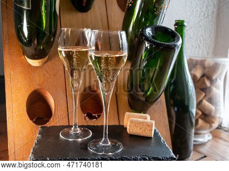 Glasses Of Sparkling White Wine Champagne Or Cava With Bubbles And Classic Wooden Champagne Pupitre