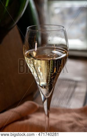 Glass Of Sparkling White Wine Champagne Or Cava With Bubbles And Classic Wooden Champagne Pupitre Ra