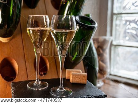 Glasses Of Sparkling White Wine Champagne Or Cava With Bubbles And Classic Wooden Champagne Pupitre