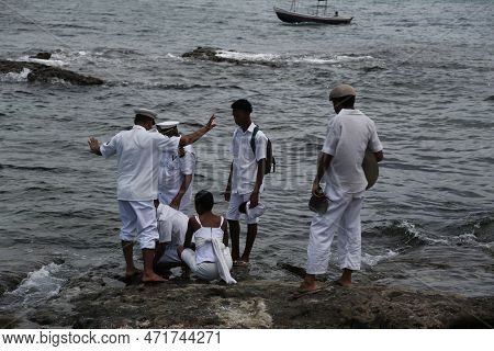 Salvador, Bahia, Brazil - January 1, 2023: Members Of Candombles Make Offerings On The Beach In Umai