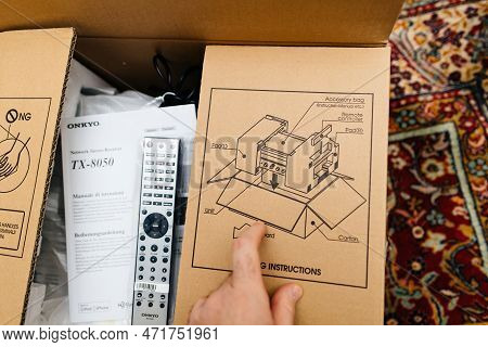 Frankfurt, Germany - Feb 23, 2023: Pov Male Hand Unboxing Unpacking New Onkyo Cardboard Of A Video A