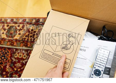 Frankfurt, Germany - Feb 23, 2023: Pov Male Hand Unboxing Unpacking New Onkyo Cardboard Of A Video A