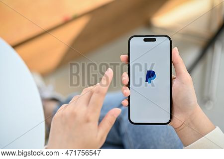 Chiang Mai, Thailand - Feb 28 2023: Iphone With Paypal Logo On Screen, A Woman Using Paypal Applicat