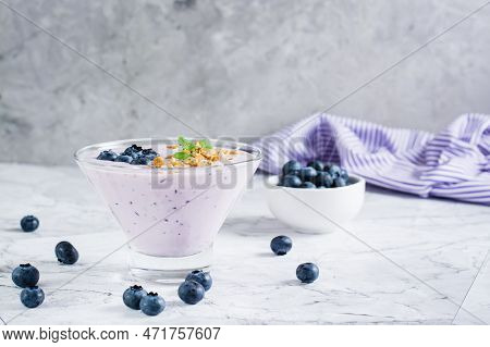 Smoothies With Blueberries And Granola In A Bowl On The Table. Organic Antioxidant Healthy Food.