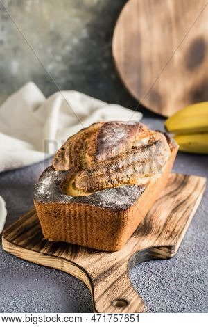 A Loaf Of Baked Banana Bread On A Cutting Board On The Table. Social Media Trendy. Vertical View