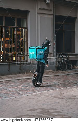 Riga, Latvia - June 8, 2022: Wolt Food Delivery Using Electric Unicycle