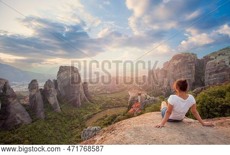 Woman Overlooking The Rockformations Of Meteora At Sunset