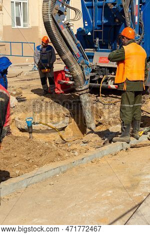 Workers Use A Suction Excavator Based On A Man Truck To Sample Soil In A Well For Communications