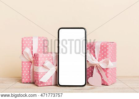 Mobile Phone With Blank Screen On Colored Background With Hearts, Calendar And Gift Box, Valentine D