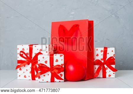 Shopping Bag With Gift Box On Colored Background Perspecrive View. Space For Text Holiday Concept.