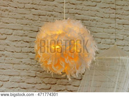 Modern Lamp With Abajur Made Of White Feathers, Gives Romantic Light In Bedroom
