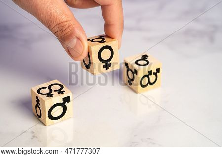 Exploring Gender Diversity: A Person Selecting Through A Cube On Its Different Sides All The Current