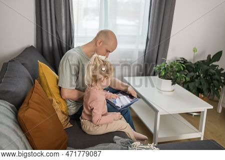 People With Cochlear Implant System. Kid Study To Hear With Her Father, Learning With Video On Table