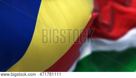 Close-up View Of The Seychelles National Flag Waving In The Wind. Five Oblique Bands Of Blue, Yellow