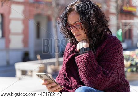 Woman Chatting With Her Smartphone In A Sunny Day