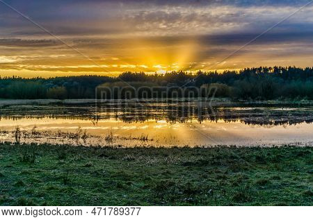 A Golden Sunset At The Nisqually Wetlands Estuary In Washington State.