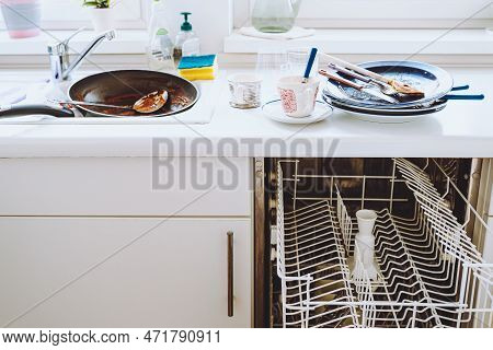Pile Of Dirty Unwashed Dishes On Kitchen Surface, Small Dishwasher, White Kitchen Facades. Dirty Dis