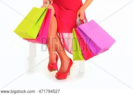 A Picture Of A Young Woman Sitting With Shopping Bags Over White Background