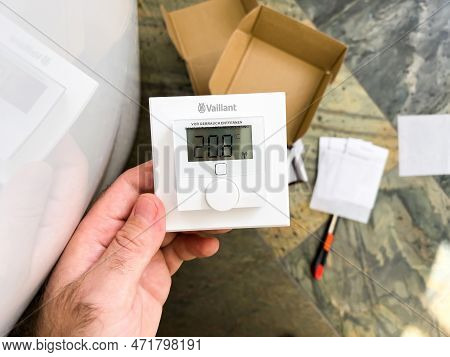 London, United Kingdom - Jan 1, 2022: Close-up Male Hand Holding New Socket Plug Vaillant Ambisense 