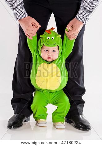 the small child in a suit of a dragon
