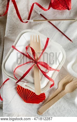 Closed Bento Cake Box With A Wooden Spoon Tied Red Ribbon. Gift Box With Tasty Bento. Cake Packaging