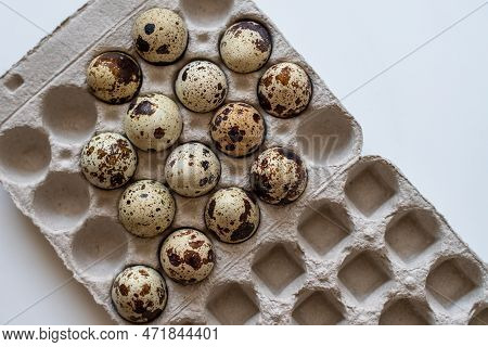 Spotted Quail Eggs In An Egg Box On A Light Background, Natural Eco-friendly Products.