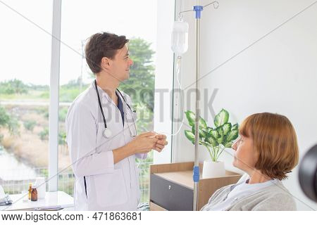 The Doctor Is Examining The Patient In The Hospital. Caucasian Doctor Wearing Gown And Stethoscope L