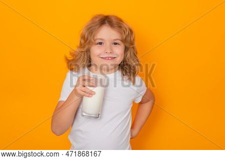 Kid Drink Milk With Funny Emotions On Yellow Background. Child Drinking Milk, Studio Portrait. Cute 