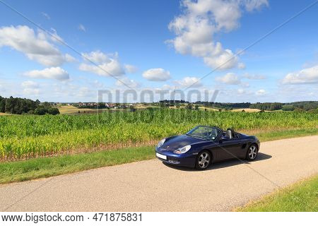 Schopfloch, Germany - July 31, 2021: Blue Roadster Porsche Boxster 986 With Corn Field Panorama At R