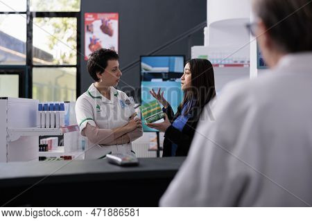 Unsatisfied Customer Returning Expired Aspirin Tablets Box At Drugstore Counter Desk. Pharmaceutical