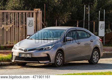 Side, Turkey -january 21, 2023:    Silver Oyota Corolla   Is Parked  On The Street On A Warm  Day Ag