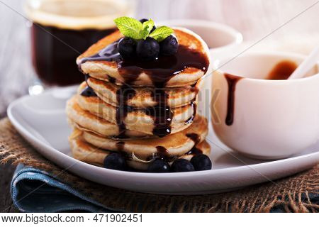 Eggless Pancakes For Breakfast With Blueberries And Chocolate Sauce