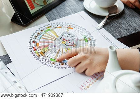 Tver, Russia - February 12, 2023: A Woman At The Table Is Studying A Rave Mandala By Human Design. R