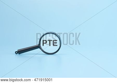 Look At The Text Pte Through A Magnifying Glass On A Blue Background