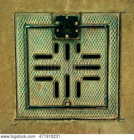 Colorful Utility Manhole Cover Convey An Aging Industrial Era, Made Of Sturdy Metal With A Patina Of