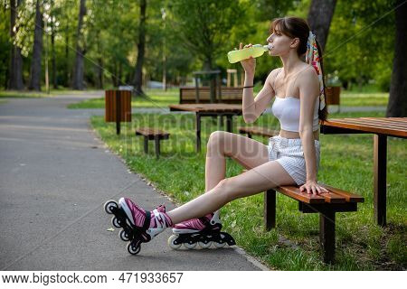 On A Hot Day, A Girl Replenishes Electrolytes While Playing Sports.