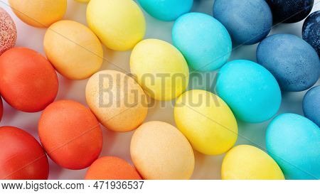 Easter Rainbow Colored Eggs Background. Colored Eggs Are Laid Out In A Gradient And Diagonally On A 