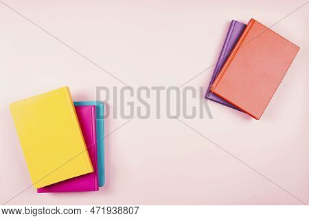 Colorful Hardcover Books On Pastel Pink Background. Education, Self-learning, Book Swap, Bookcrossin
