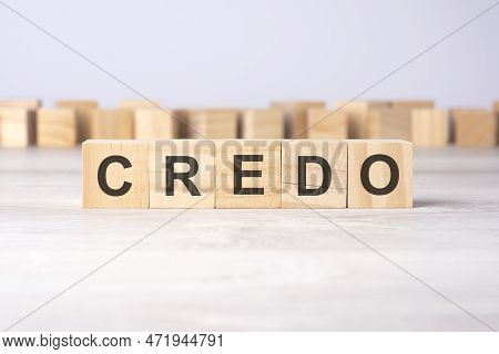 Word Credo Inscribed On Wooden Cubes Lying On A Light Table. Economy And Investments Concept.