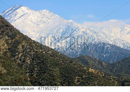 Arid Foothills Covered With Chaparral Plants Including Alpine Peaks Covered With Snow During Winter 