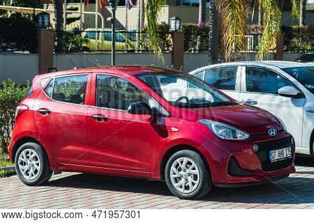 Side, Turkey - January 23 , 2023 :     Red Hyundai I10  Is Parking  On The Street On A  Summer Day A