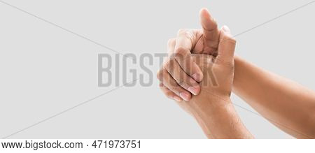 A Man Cracking Their Knuckles. On A Gray Background. Copy Space