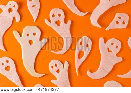 White Ghosts Kids Craft For Halloween. Wrapping Paper Ghost On Orange Background Top View. A Scary A