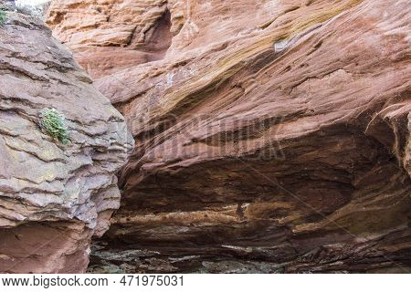 A Large Rock Formation On Rocky Coastline, Wonder Of Nature. Waves In The Process Of Erosion Eroded 