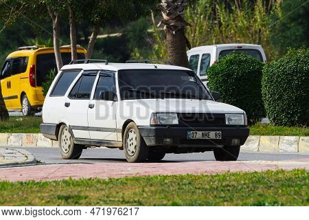 Side, Turkey -january 27, 2023:     White Tofas Dogan  Driving  On The Street On A Warm Summer Day