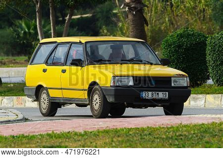 Side, Turkey -january 27, 2023:      Yellow Tofas Dogan  Driving  On The Street On A Warm Summer Day