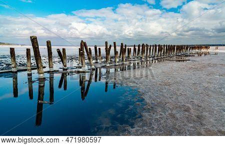 Salt Crystals On Wooden Pillars Of An Old 18Th Century Salt Industry. The Ecological Problem Is Drou