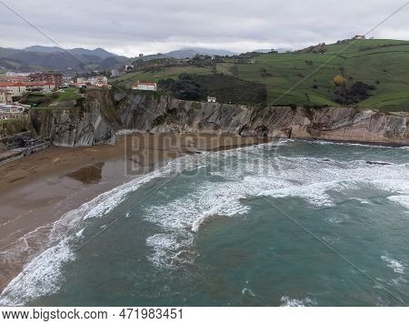 View On Sandy Beach, Rocks And Atlantic Ocean In Zumaia Touristic Ciry, Basque Country, Spain